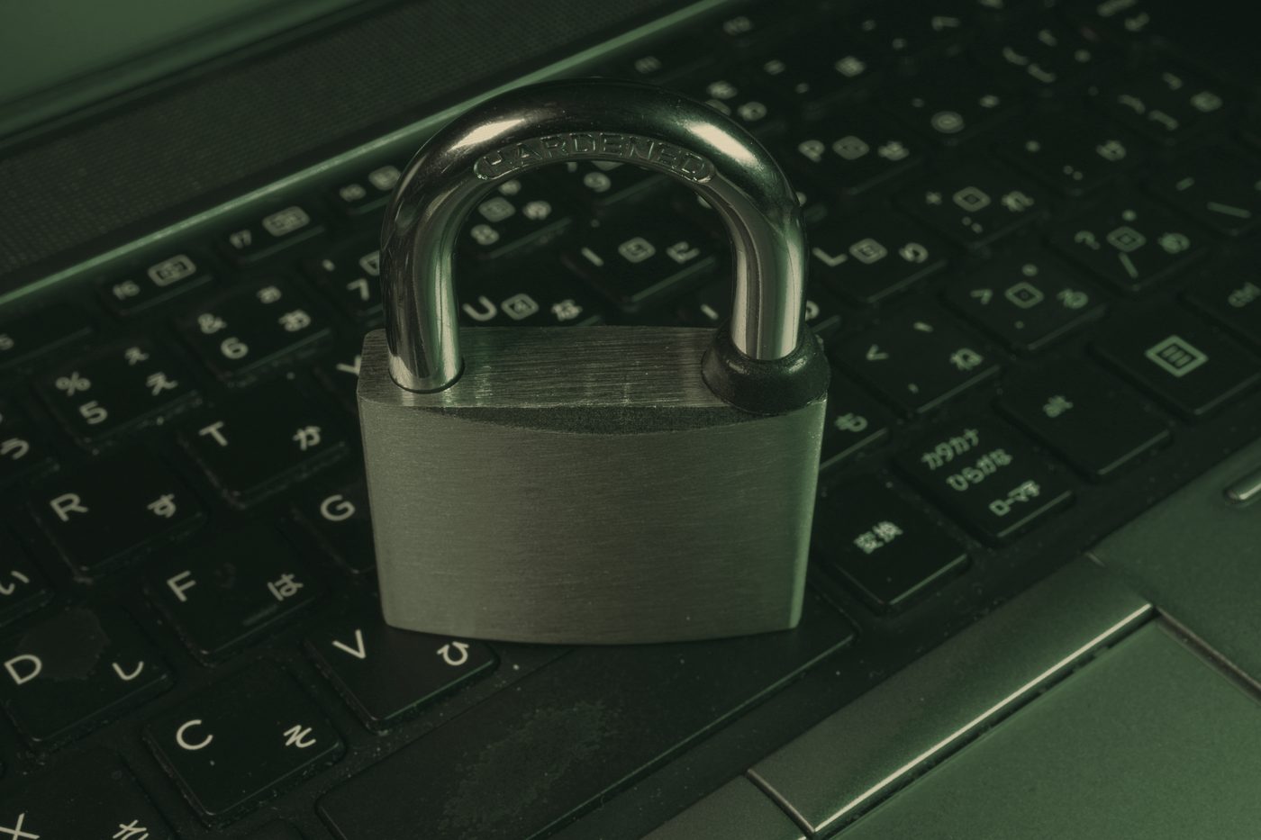 A padlock resting on a laptop keyboard.